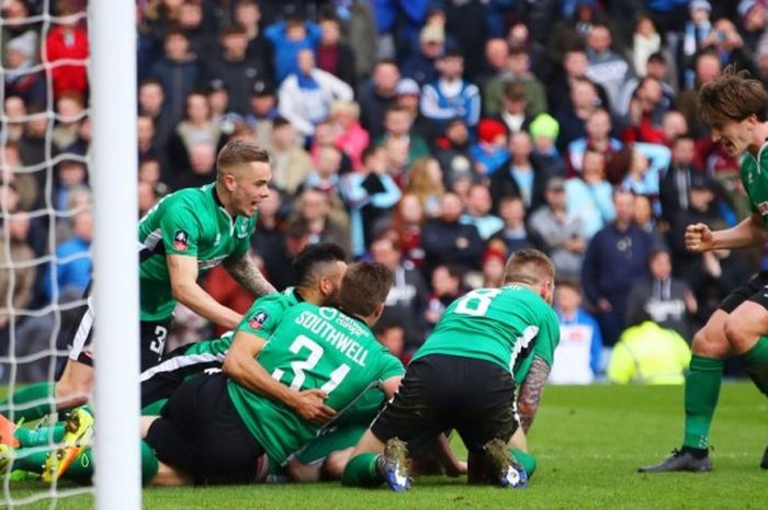 Para pemain Lincoln City merayakan gol kemenangan tim yang dicetak Sean Raggett pada pertandingan babak 16 besar Piala FA 2016-2017 atas Burnley di Stadion Turf Moor, Burnley, Inggris, pada Sabtu (18/2/2017).