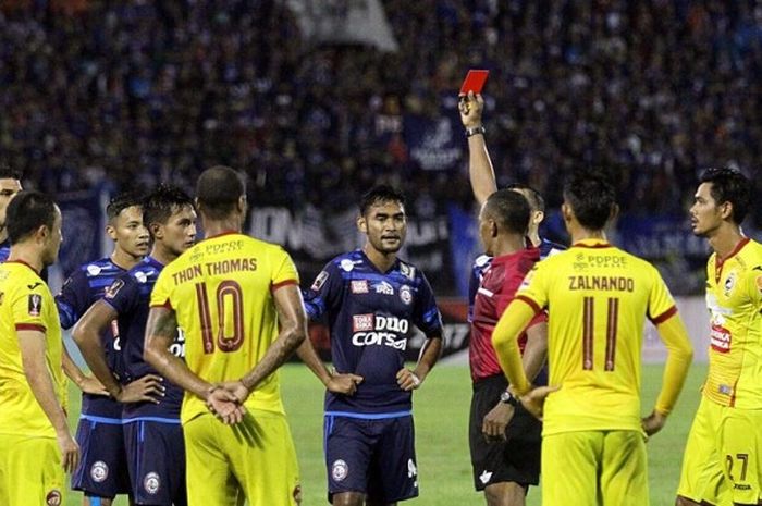 Pemain Arema FC, Ferry Aman Saragih saat mendapatkan kartu merah dari wasit Abdul Rahman Salasa dalam laga kontra Sriwijaya FC pada perempat final Piala Presiden 2017 di Stadion Manahan, Solo, Minggu (26/2/2017).