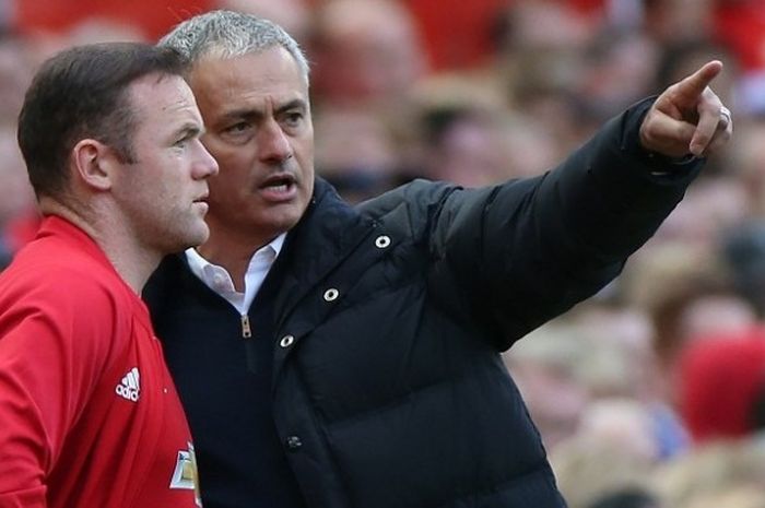  Manajer Manchester United, Jose Mourinho (kanan), berbincang dengan salah satu pemainnya, Wayne Rooney, dalam laga Premier League kontra Stoke City, di Stadion Old Trafford, 2 Oktober 2016.  