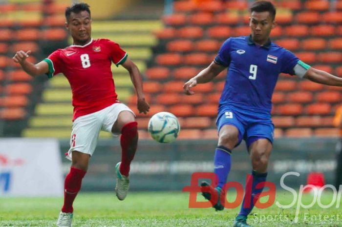 Gelandang timnas Indonesia, Muhammad Hargianto, berudel memperebutkan bola dengan kapten timnas Thailand, Chenrop Samphaodi, pada partai pembuka Grup B SEA Games 2017 di Stadion Shah Alam, Malaysia, Selasa (15/8/2017).