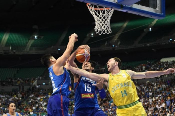 Pemain Australia (jersey kuning) dan pemain Filipina (jersey biru) saat berebut bola rebound pada pertandingan kualifikasi FIBA World Cup 2019 zona asia yang berlangsung Senin (2/7/2018).