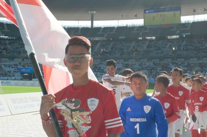 Mulkan Hanif memimpin Tim AQUADNC Garuda Muda 2016 memasuki Stade De France untuk melakoni pertandingan perebutan peringkat ke-11 Final Dunia Danone Nations Cup 2016 melawan Tunisia, Minggu (16/10/2016).