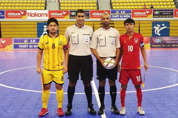 Kapten tim futsal Brunei, Muhammad Naqib (kiri) dan kapten tim futsal Myanmar, Aung Aung (kanan) bersama wasit berpose sebelum memulai laga perdana Grup A Piala Futsal AFF 2017 di Stadion Phu Tho, Ho Chi Minh City, Vietnam, Kamis (26/10/2017). 