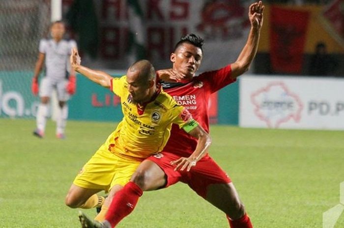 Gelandang Semen Padang, Irsyad Maulana (kanan), dan fullback Sriwijaya FC, Supardi Nasir (kiri), saat berjibaku dalam laga kedua  tim pada pekan ke-27 Kejuaraan Sepak Bola Torabika (TSC) 2016 di Stadion Gelora Sriwijaya, Palembang, Jumat (4/11/2016).