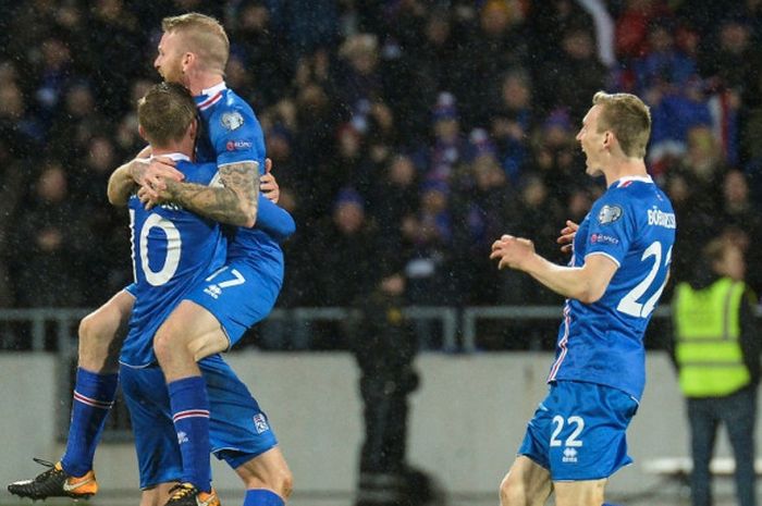 Pemain Islandia, Gylfi Sigurdsson, Aron Gunnarsson, dan Jon Dadi Bodvarsson, merayakan kemenangan atas Kosovo dalam laga Kualifikasi Piala Dunia 2018 di Reykjavik, Islandia, pada 9 Oktober 2017.