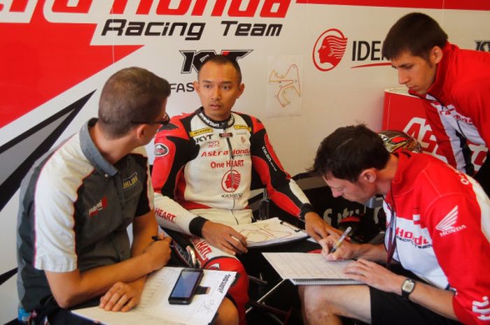 Pebalap Astra Honda Racing Team, Dimas Ekky Pratama (kedua dari kiri), sedang berbincang dengan kru tim balapnya. Dimas berkiprah di kelas Moto2 European Championship.