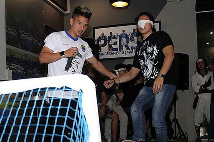 Gelandang Persib Bandung, Kim Jeffrey Kurniawan (kiri) memandu bintang film Wiro Sableng, Vino G. Bastian dalam gim tendangan penalti dengan mata tertutup dalam acara Meet and Greet pemain Persib dan pemain film Wiro Sableng di 1933 Dapur & Kopi, di jalan Sulanjana, Kota Bandung Jumat (31/8/2018).