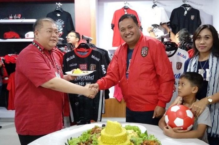 CEO Bali United, Yabes Tanuri (kiri), berjabat tangan dengan Wakil Bupati Gianyar, I Made Mahayastra (kanan), seusai pemotongan tumpeng dalam peresmian merchandise store Bali United di area Stadion Kapten I Wayan Dipta, Gianyar, Jumat (9/6/2017).
