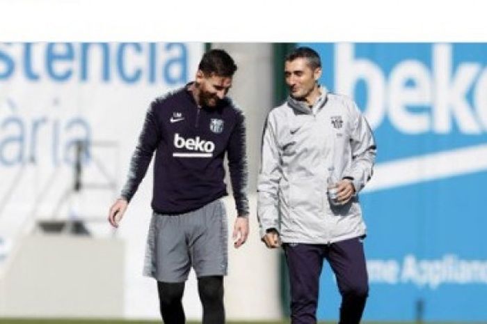 Pelatih FC Barcelona, Ernesto Valverde (kanan), berbicara dengan Lionel Messi dalam sesi latihan tim