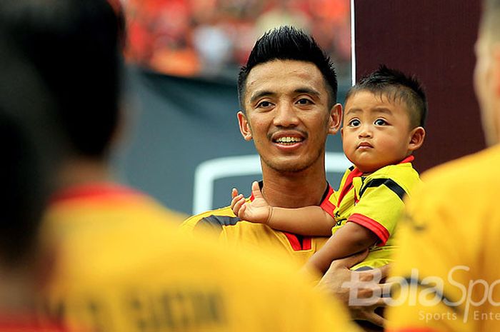 Kapten Mitra Kukar, Bayu Pradana, menggendong putranya, Rui Costa Zafran Pranda, menjelang dimulainya laga melawan Persija Jakarta pada babak delapan besar Piala Presiden 2018 di Stadion Manahan, Solo, Minggu (4/2/2018).