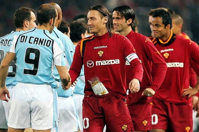 Kapten AS Roma, Franceso Totti (kanan depan), berjabat tangan dengan Paolo Di Canio dari Lazio pada duel derbi ibu kota Italia di Serie A, 6 Januari 2005.