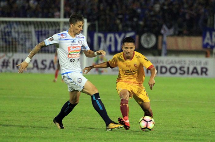 Pemain Sriwijaya FC, Syahrian Abimanyu saat mencoba melewati pemain Arema FC, Rodrigo Ost, di Stadion Manahan, Solo, Minggu (4/2/2018)