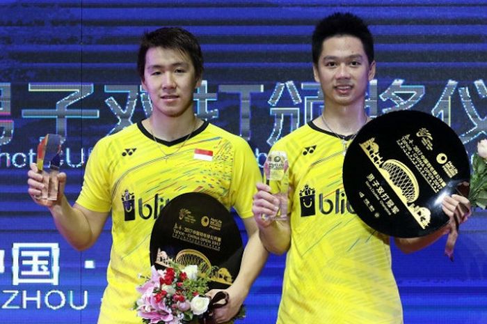 Pasangan ganda putra Indonesia, Marcus Fernaldi Gideon/Kevin Sanjaya Sukamuljo, berpose seusai memenangi laga final China Open 2017 di Haixia Olympic Sports Center, Minggu (19/11/2017).