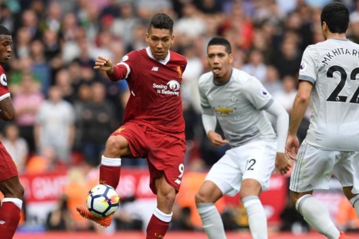 Striker Liverpool, Roberto Firmino (tengah), mengontrol bola di antara pengawasan pemain Manchester United dalam partai Liga Inggris di Anfield, Liverpool, 14 Oktober 2017.