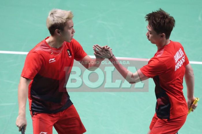  Marcus Fernaldi Gideon (kiri) dan Kevin Sanjaya Sukamuljo (kanan) saat melakoni partai final bulu tangkis nomor ganda putra Asian Games 2018, Selasa (28/8/2018). 