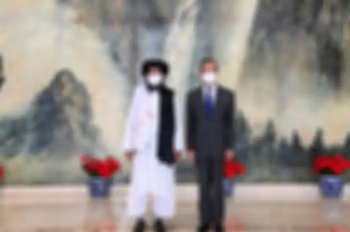 Chinese State Councilor and Foreign Minister Wang Yi meets with Mullah Abdul Ghani Baradar, political chief of Afghanistan's Taliban, in Tianjin, China July 28, 2021. Picture taken July 28, 2021. Li Ran/Xinhua via REUTERS   ATTENTION EDITORS - THIS IMAGE WAS PROVIDED BY A THIRD PARTY. CHINA OUT. NO 