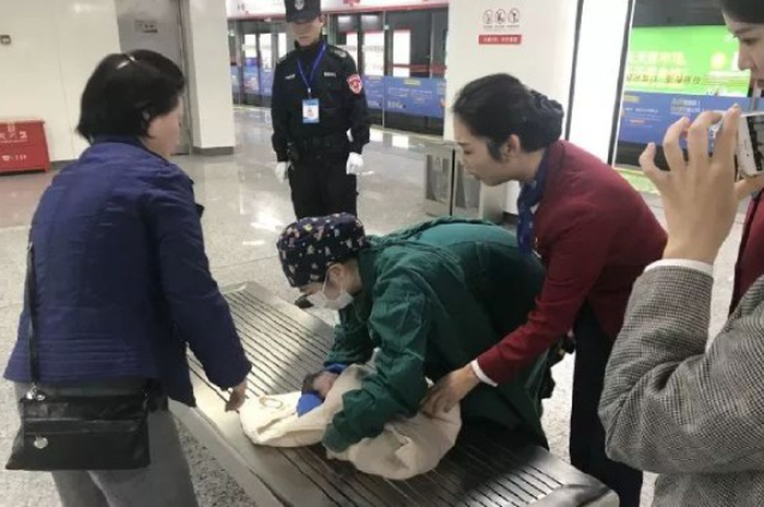  Seorang wanita melahirkan bayi di platform stasiun kereta bawah tanah dengan bantuan anggota staf kereta bawah tanah dan paramedis.