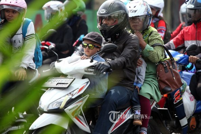 Naik motor bonceng tiga
