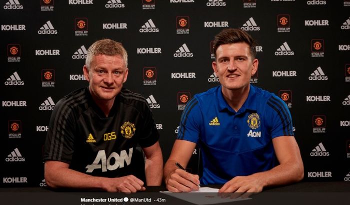 Harry Maguire (kanan) menandatangani kontrak dengan Manchester United didampingi pelatih klub, Ole Gunnar Solskjaer.