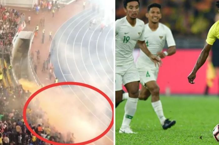 Fans Malaysia melemparkan flare ke arah tribune pendukung timnas Indonesia.