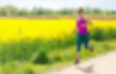 Woman runner happy running jogging on sunny day
