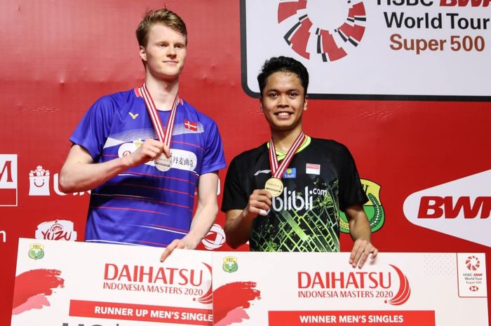 Pebulu tangkis tunggal putra Indonesia, Anthony Sinisuka Ginting, berpose di atas podium bersama Anders Antonsen (Denmark) usai menjalani laga final Indonesia Masters 2020 di Istora Senayan, Jakarta, Minggu (19/1/2020).