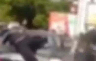 Bak film action seorang pria nekat lompat ke atas mobil usai tabrak seorang pemotor.