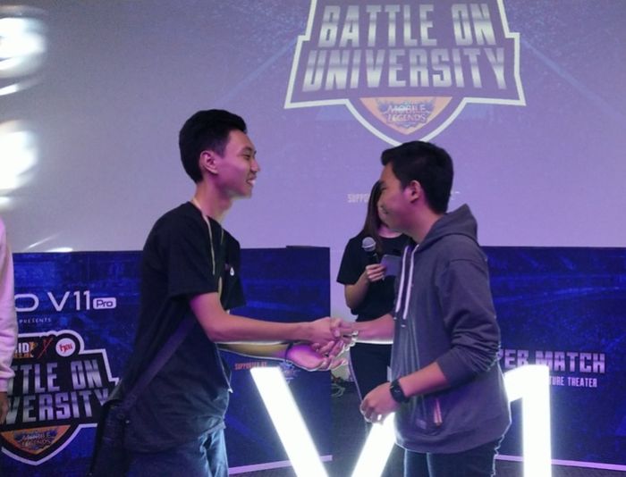 Team Kristoforus 2 and Team Dharma Widia shake hands when the game is over