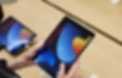 Pengunjung Apple Store mencoba mengoperasikan iPad 9