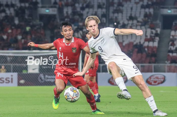 Striker timnas U-20 Selandia Baru, Kian Donkers (kanan), sedang mengoper bola dan dibayangi pemain timnas U-20 Indonesia bernama Robi Darwis (kiri) dalam laga turnamen Mini Internasional di Stadion Gelora Bung Karno, Senayan, Jakarta, Minggu (19/2/2023) malam.