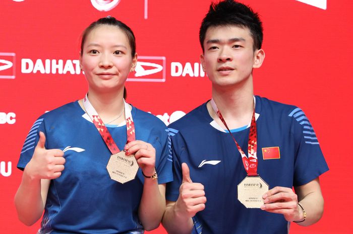 Ganda campuran China, Zheng Siwei (kanan) dan Huang Yaqiong (kiri), saat memamerkan medali juara.