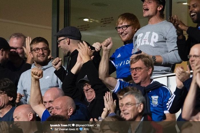 Ed Sheeran (tengah) ketika menyaksikan pertandingan antara Ipswich Town Vs AFC Wimbledon pada Selasa (20/8/2019) di Stadion Portman Road dengan mengenakan jersey tim kebanggaannya.