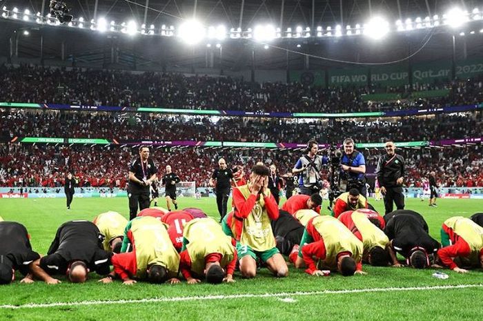 Para pemain timnas Maroko melakukan sujud syukur usai menang dalam suatu laga di Piala Dunia 2022.